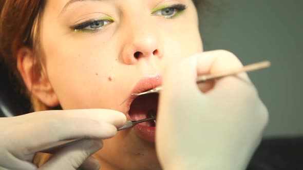 Girl shaking hands with dentist while sitting in the chair