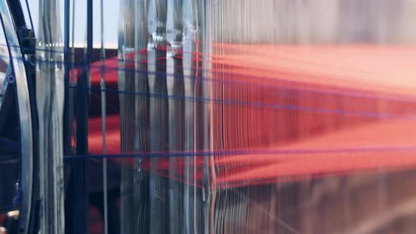 Close Up of a Weaving Mechanism Processing Threads