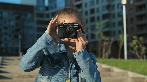 Portrait of a Little Girl Holding a Camera