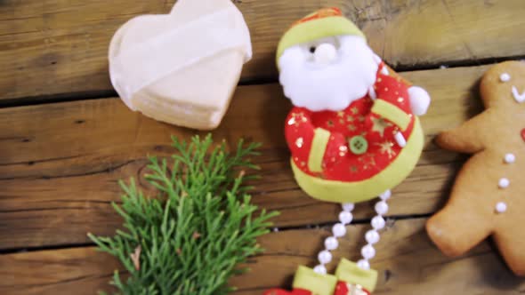 Santa claus with gingerbread and cookies on wooden table