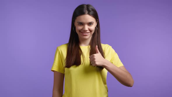 Woman Showing Thumb Up Sign on Violet Background