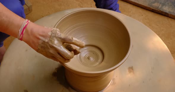 Pottery - Skilled Wet Hands of Potter Shaping the Clay on Potter Wheel. Pot, Vase Throwing