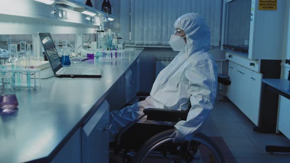 Disabled Scientist in Wheelchair Working in Lab