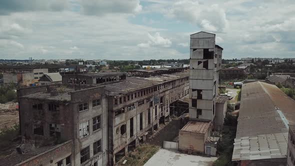 Flight over the destroyed factory. Old industrial building for demolition. Aerial view