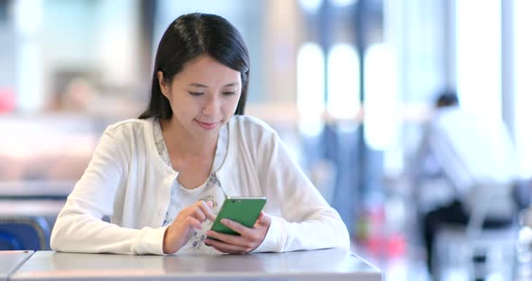 Woman look at mobile phone in restaurant