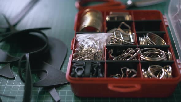Professional Tailor Hand Takes Accessory From Red Box