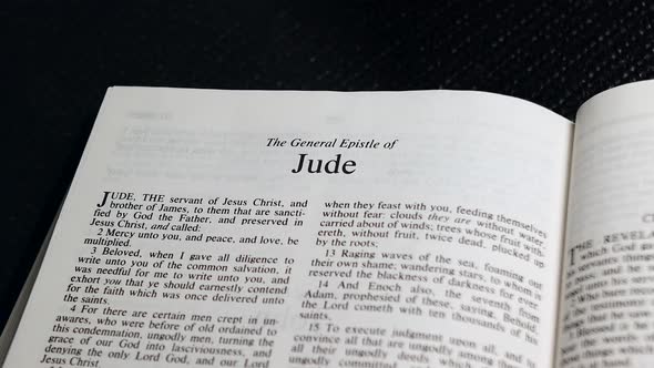 Close Up Shot of  Bible Page Turning to the book of Jude