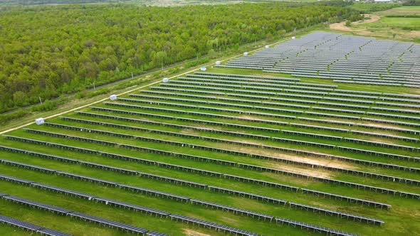 Aerial View of Big Sustainable Electric Power Plant with Many Rows of Solar Photovoltaic Panels for