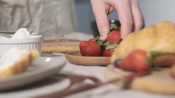 Rack Focus Girl or Woman Take Red Strawberry with Her Hand and Ready to Cut It It to Decorate