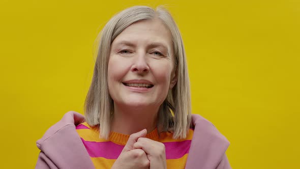 Face Of Elderly Woman In Sportswear On Yellow Background