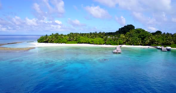 Tropical aerial abstract shot of a white paradise beach and blue water background in colorful 4K