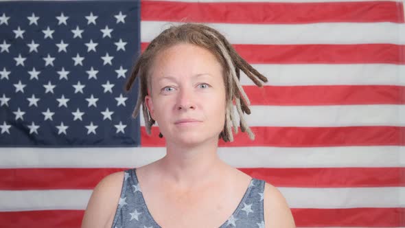 Portrait of proud American woman on background of USA flag