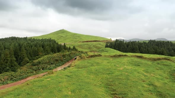 Couple on Motorcycle Riding on Road in Mountains Sao Miguel Island Azores