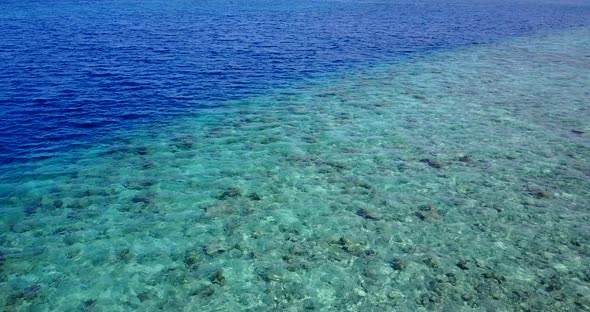 Daytime aerial tourism shot of a summer white paradise sand beach and blue water background in high 