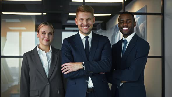 Smiling people in a suit in the office. Business people looking at camera