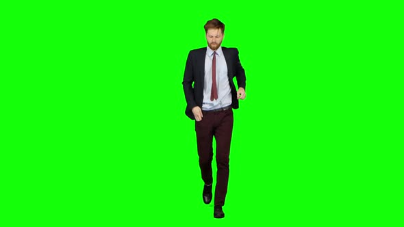 Man Is Running a Telephone Rings To Him and He Talks. Green Screen