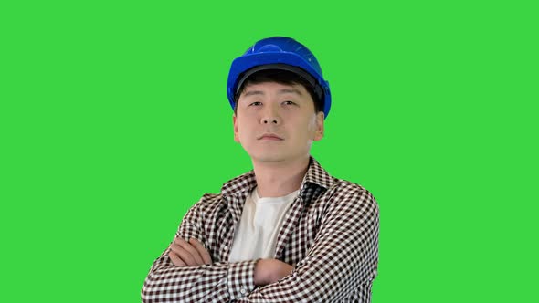 Construction Worker in a Hardhat Changing Poses and Looking to Camera on a Green Screen Chroma Key