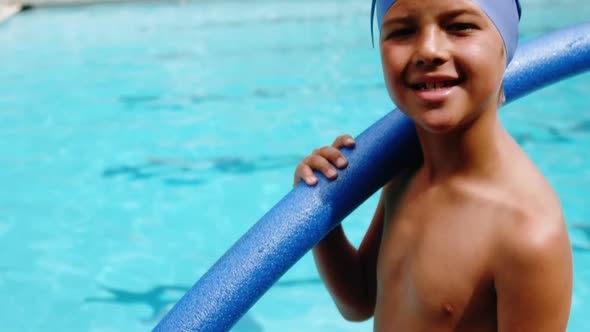 Portrait of young boy holding inflatable tube