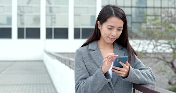 Businesswoman check on smart phone in city