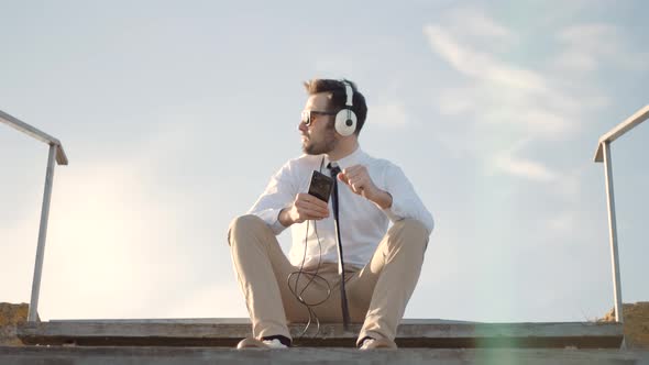 Businessman Relaxing Enjoying After Good News Having Fun Work Break Outdoors. Man Listening To Music