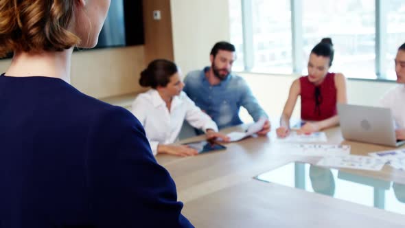 Business colleagues discussing over document