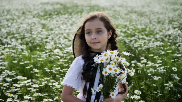 Girl in a White Dress of Seven Years with Big Eyes