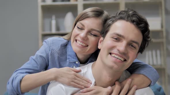 Smiling Romantic Young Couple in Love Looking at Camera