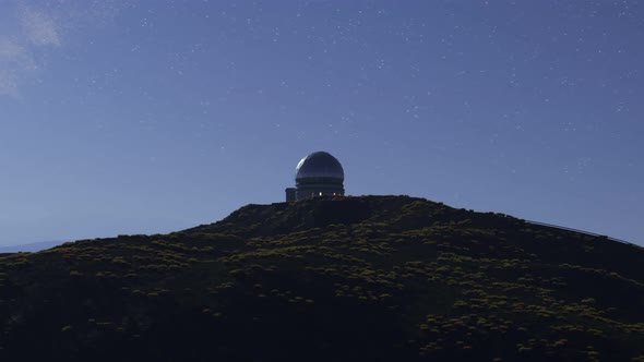 A modern astronomical observatory in a vast meadow valley during night. 4KHD