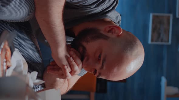 Vertical Video Traumatised Man with Tears Sitting on Couch Crying Feeling Exhausted