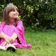 Girl wearing pink dress and tiara sitting on grass - VideoHive Item for Sale