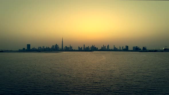 Grading aerial view of Dubai skyscrapers at sunset, UAE.