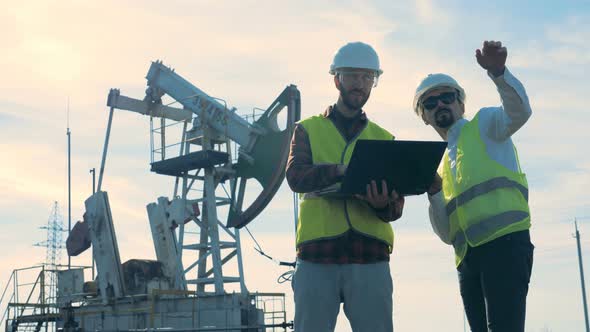 One Energetics Expert Is Giving Instructions To Another One While Being in Oil Extraction Site