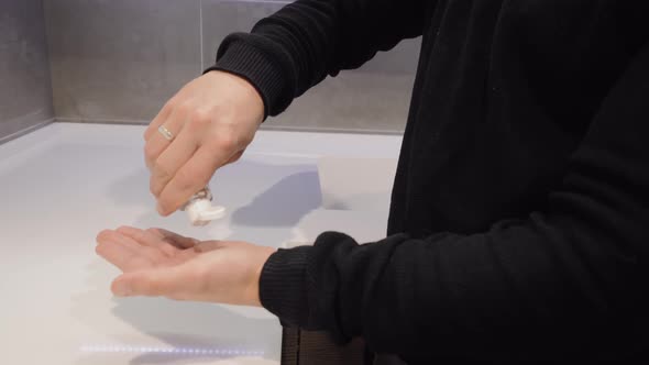 A Man Puts a Disinfectant Gel on His Hands