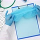 female hands in blue letax gloves hold a disposable medical cap - VideoHive Item for Sale