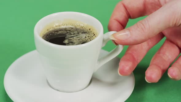 Hand taking a coffee cup