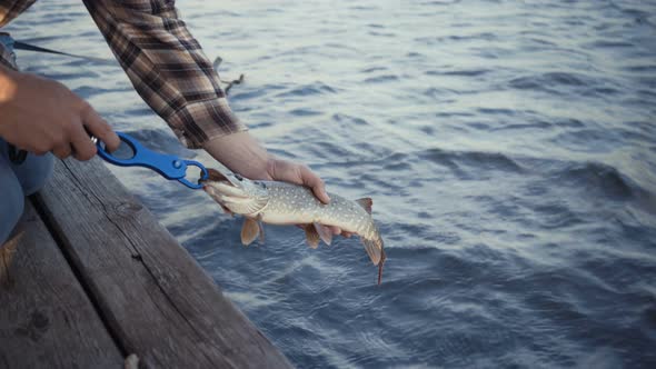 Young Fisherman Actively Fishing at Lake