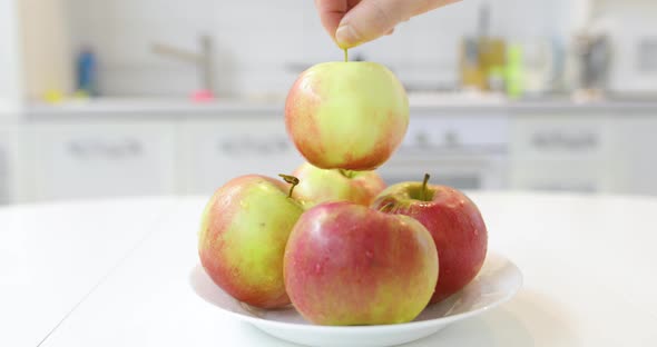 Male Hand Take Fresh Clean Ripe Apple From Plate
