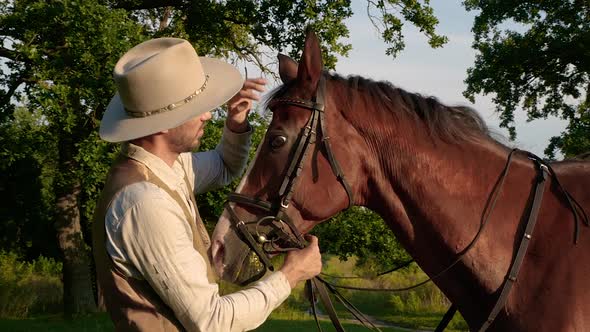 Close Up of American Cowboy Stroking Horse in Slow Motion