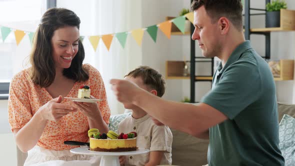 Happy Family Eating Birthday Cake at Home Party