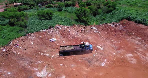 Truck throwing garbage on abandoned ground, pollution only increases, human being is not aware and n