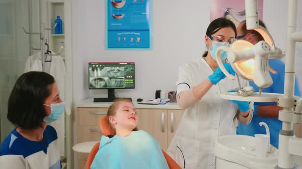 Stomatologist Holding Sterilized Dental Tools Talking with Little Patient