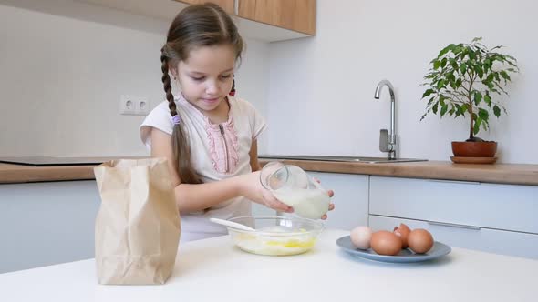 Little Girl Learns to Cook in the Kitchen and Make Bakery