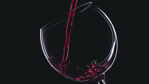 Red wine in wineglass on black background