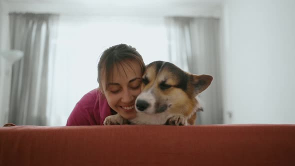 Lovely Brunette Woman with Funny Cute Welsh Corgi Dog