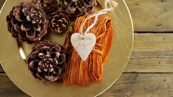 Pine cones and heart shape decoration in a plate 4k