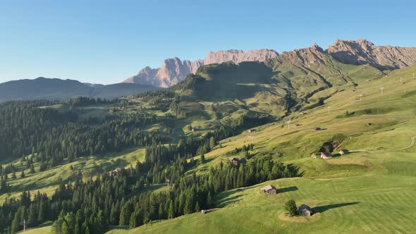 Dolomites cottages under the rugged mountains peaks at sunrise