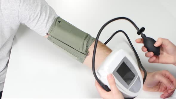 Closeup of Sphygmomanometer Being Used of Woman Doctor