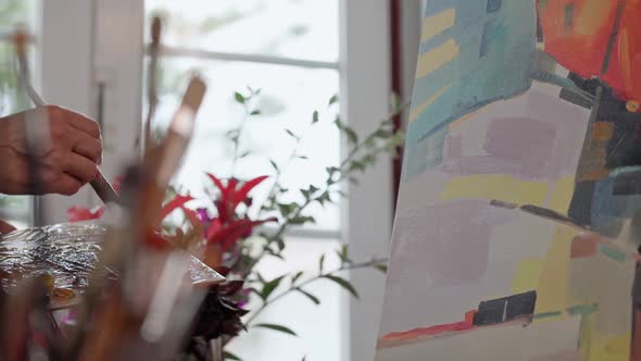 Woman Artist Applying Paint with Brush Strokes on Canvas Brush Closeup