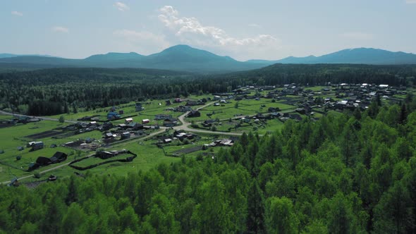 Aerial View of Mountain Range in Ural and Little Households