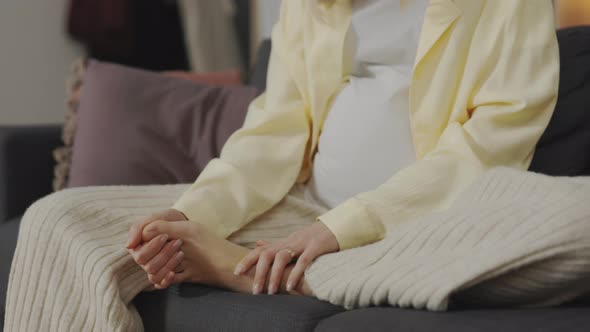 Close Up of Pregnant Woman Massaging Swollen Foot